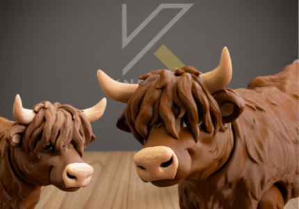 Two brown cow statues on a wooden floor with a dark gray background.