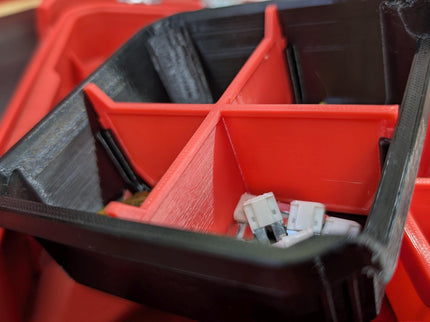 Red plastic tool organizer with compartments, showing a close-up of its interior.