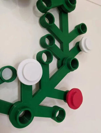 Green and red plastic tree-like structure on a white background