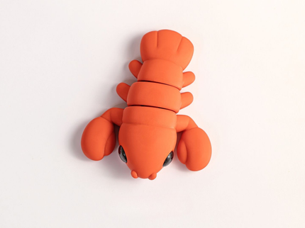 Orange lobster-shaped object on a white background