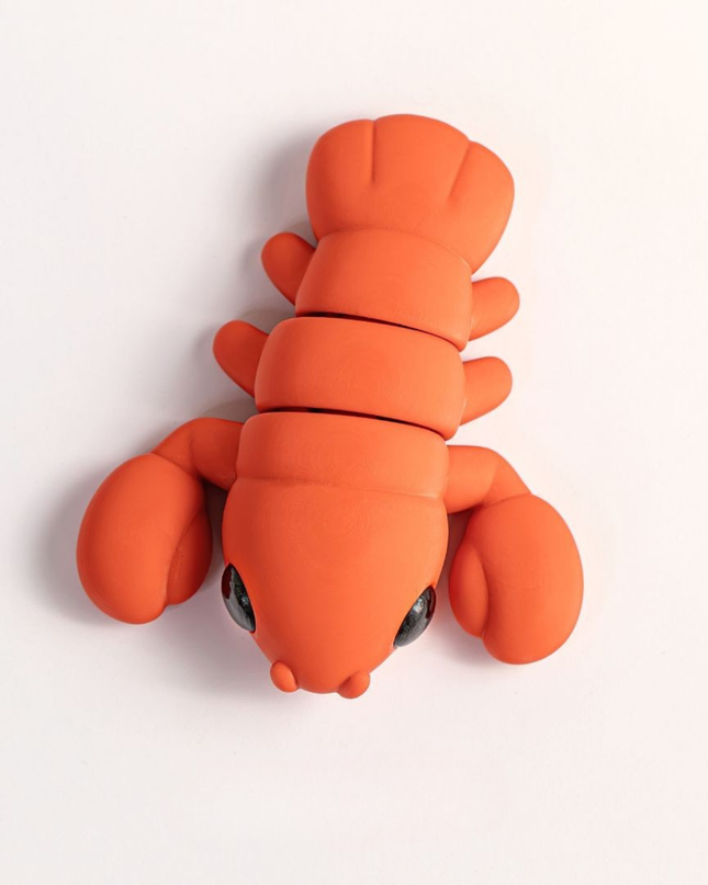 Orange lobster-shaped object on a white background