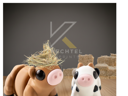 Two small articulated cow figures sit on a wooden surface in front of hay bales. The brown cow wears a tuft of straw on its head while the white cow with black spots looks on. The background features a soft gray wall with the Knechtel 3D Prints logo faintly visible, giving the scene a cozy barnyard feel.