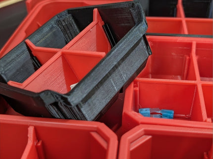 Red storage bins with a black divider included, labeled 'Packout Middle Square Slim Bins'.