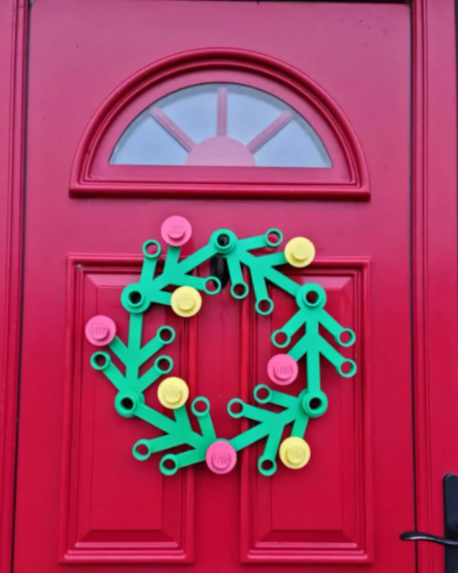 Colorful wreath decoration on a red door