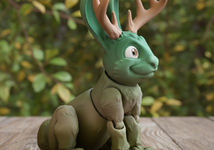 Green and brown 3d printed jackalope - a folklore creature with antlers on a wooden surface with a blurred natural background