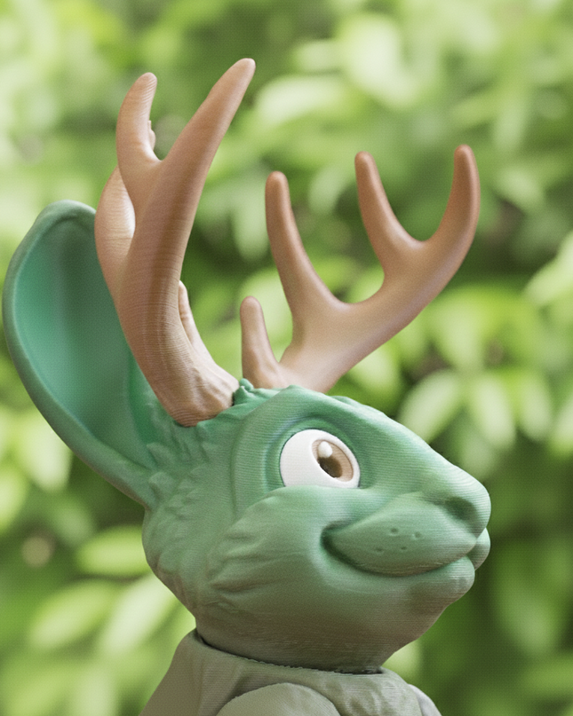 Green 3d printed jacklaope - a folklore forest creature with deer antlers against a blurred green background