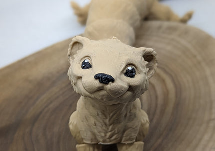 a close up of a 3d printed ferret toy standing on a wooden base with a white background