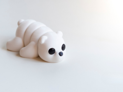 White bear figurine on a light gray background