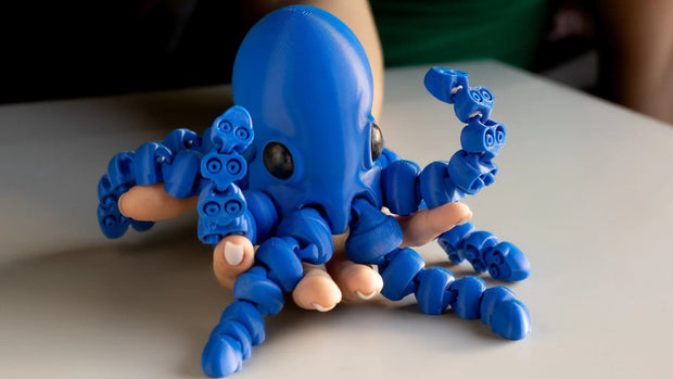 Blue octopus toy made of interlocking bricks on a neutral background