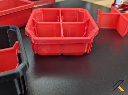 Red plastic compartmentalized tray on a dark surface