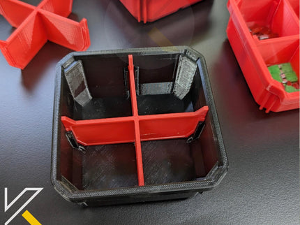 Red plastic tray with compartments on a dark surface