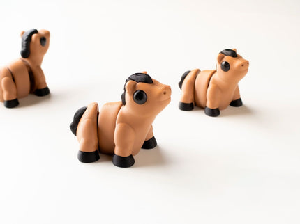 Three horse toys on a white background