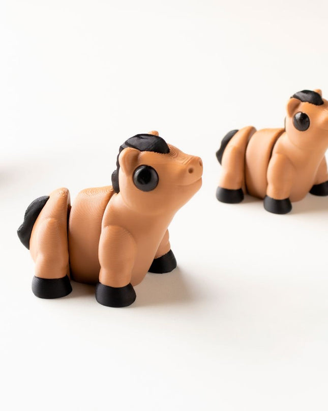 Three horse toys on a white background