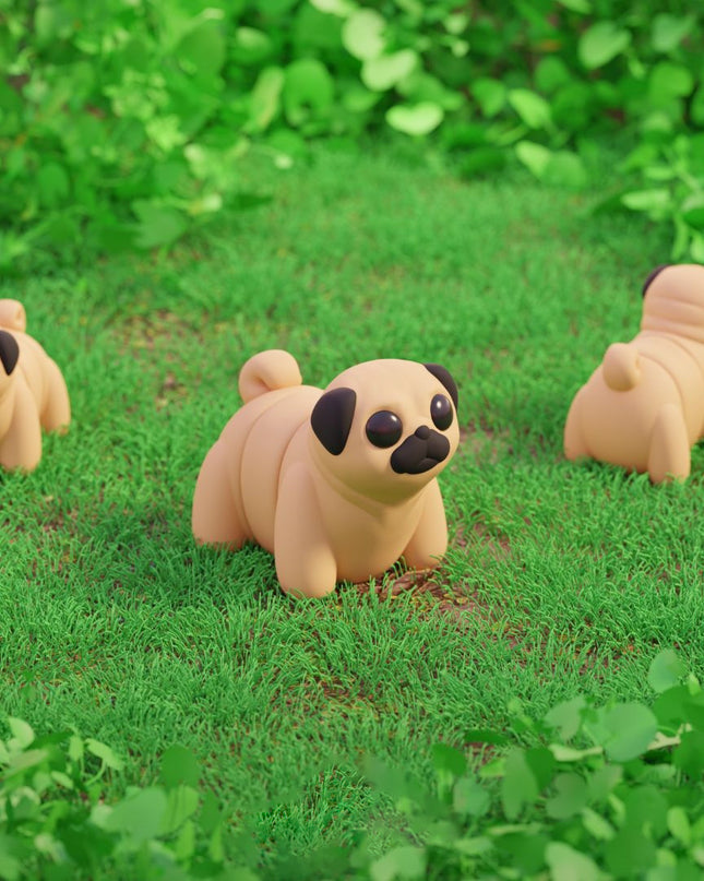 Three pug-shaped toys on a grassy field with green foliage.