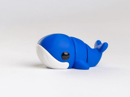 Blue and white whale-shaped object on a light gray background