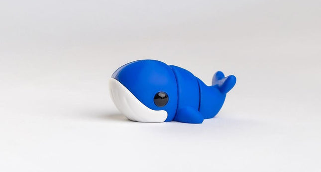 Blue and white whale-shaped object on a light gray background