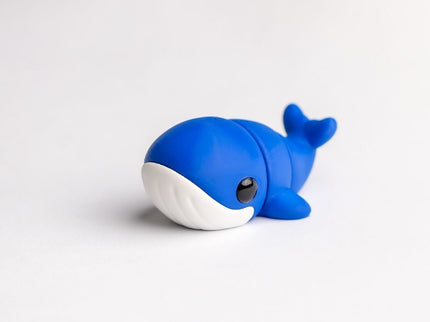 Blue toy whale on a white background