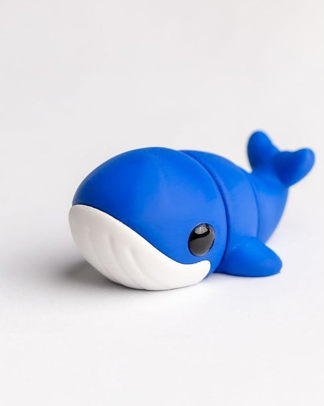 Blue toy whale on a white background