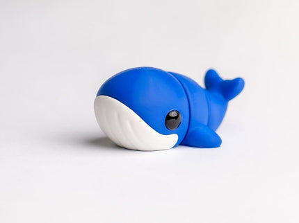 Blue toy whale on a white background