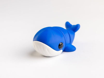 Blue whale-shaped toy on a white background
