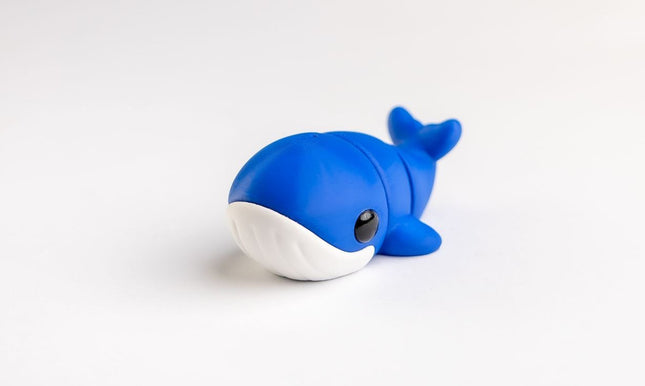 Blue whale-shaped toy on a white background